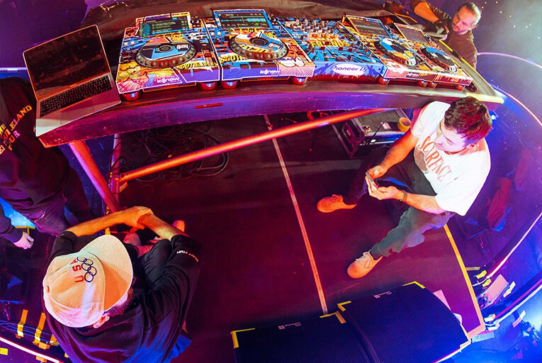 Two Friends sitting and chatting by their DJ table.